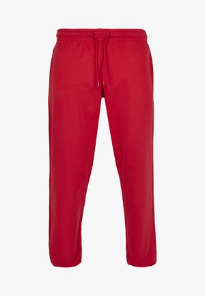 Sarkani sporta bikses ar elastīgu jostu un regulējamu zīmuļu. Izgatavotas no mīksta auduma, ar brīvu piegriezumu un bez redzamajiem rakstiem.