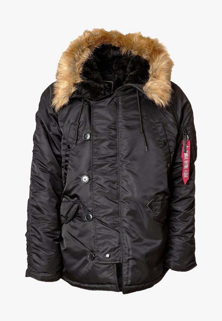 Black zip-up jacket with a faux fur-lined hood, featuring large buttons, front pockets, and a fabric tag reading "Remove Before Flight."