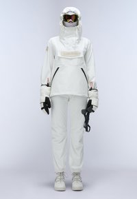White insulated ski suit with a hood, front pocket, and zippered side pockets. Includes gloves and ski goggles with a mirrored lens.