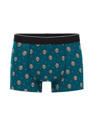 Türkiisid bokserid, millel on korduv babooni näo muster, valmistatud pehmest kangast. Must elastne vöökoht kontrastse halli õmbluse detailiga.