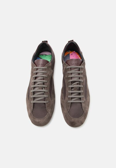 Ζευγάρι καφέ πάνινα παπούτσια από σούεντ και δίχτυ με γκρι κορδόνια και πολύχρωμες εσωτερικές σόλες με σχέδια, από πάνω, σε λευκό φόντο.