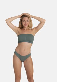 Green ribbed bandeau bikini top and matching high-waisted bottom. Fabric is textured, with a seamless design and minimal coverage.