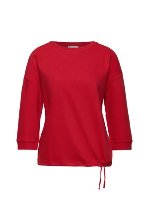Rotes Langarmoberteil mit rundem Halsausschnitt, geripptem Textil und seitlichem Kordelzug zur Anpassung der Passform am Saum.