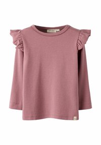 Długi rękaw w miękkim, różowym materiale z falbaniastymi akcentami na ramionach i okrągłym dekoltem. Metka widoczna w lewym dolnym rogu.