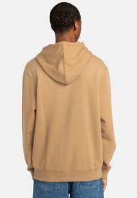 Beige hoodie with a drawstring hood, featuring a relaxed fit and ribbed cuffs and hem. Soft texture, plain design with no visible patterns.