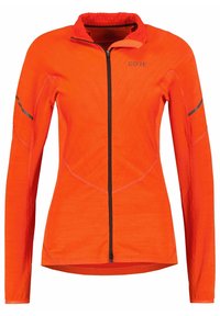 Pomarańczowa kurtka z długim rękawem, z zamkiem z przodu, teksturowany materiał, czarny zamek i akcenty oraz profilowane szwy dla dopasowanego kroju.