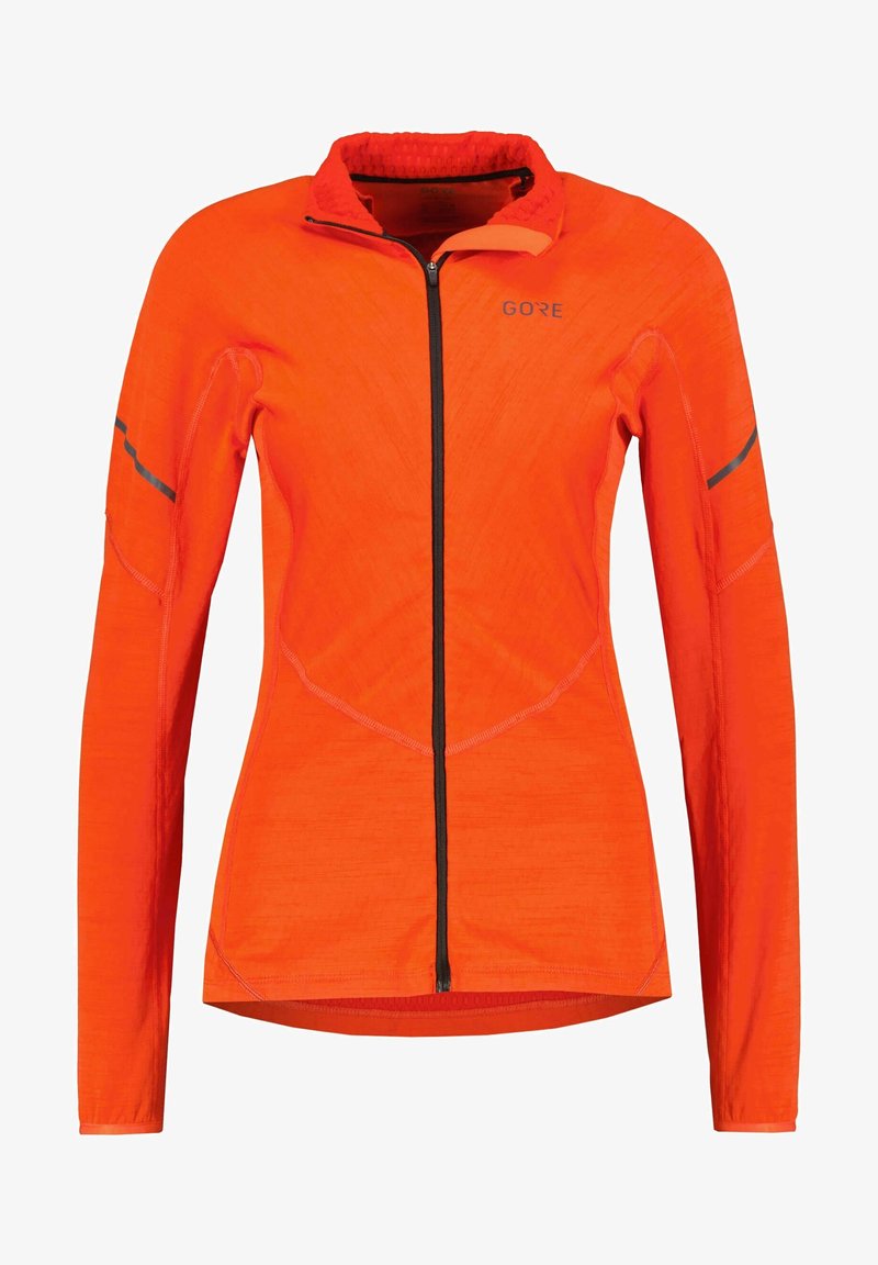 Pomarańczowa kurtka z długim rękawem, z zamkiem z przodu, teksturowany materiał, czarny zamek i akcenty oraz profilowane szwy dla dopasowanego kroju.