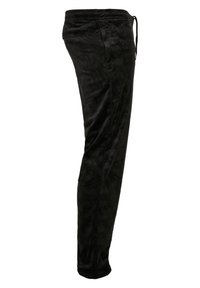 Sorte joggingbukser lavet af blødt stof med et subtilt tekstureret mønster, der har elastisk talje og manchetter for en tætsiddende pasform.