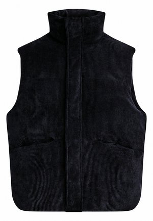 Zwarte corduroy gewatteerde bodywarmer met hoge kraag en verborgen voorzijde sluiting.