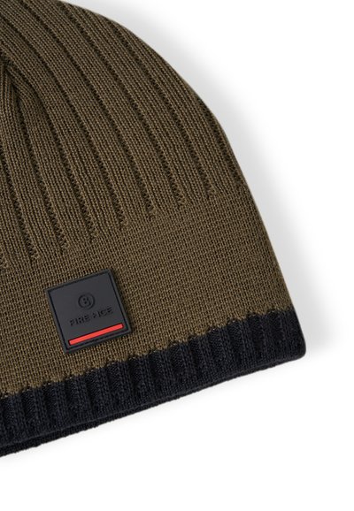 Knitted beanie in olive green with a navy ribbed cuff. Features a square black patch with red accents, enhancing the design.