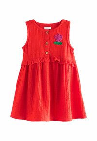 Röd, ärmlös klänning med en volangkant, med en front av träknappar och en broderad lila blomma med en grön stam. Texturerat tyg.