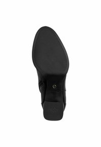 Semelle de chaussure en cuir noir avec surface texturée et légère courbure. Présente le logo "Anti Slide" et un design subtil de bout arrondi.