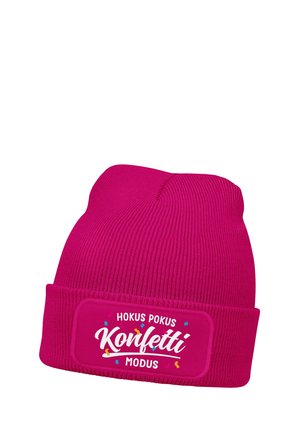 Bright pink knitted beanie hat with folded cuff and "Hokus Pokus Konfetti Modus" text and colorful confetti graphics on front label.