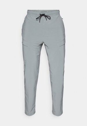 Light grey pants made of smooth fabric, featuring an elastic waistband with drawstring, side pockets, and tapered legs.