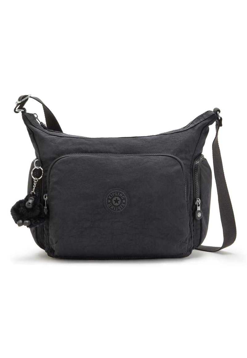 Black crossbody bag made of textured fabric with a main zip compartment, front zip pocket, and a fluffy keychain accent.