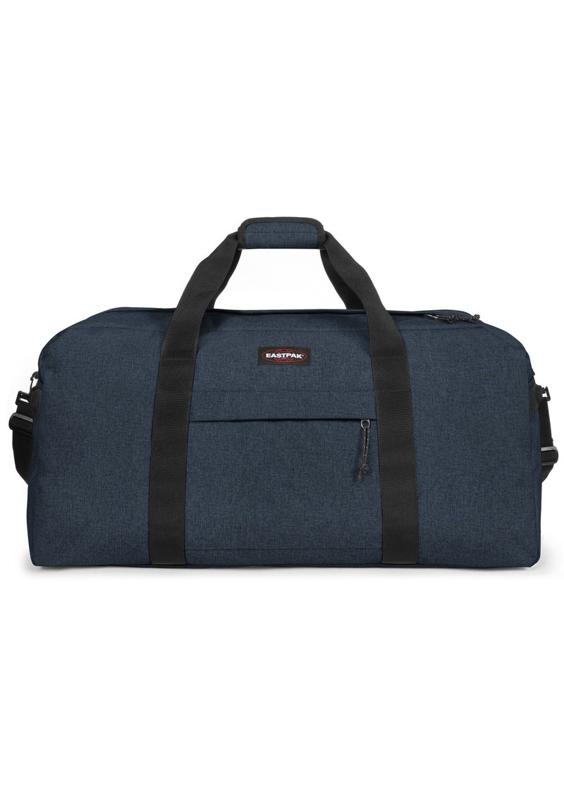 Bolsa de deporte duradera en azul marino con correas negras, un bolsillo frontal con cremallera y forma rectangular. Hecha de una tela texturizada. El logo de la marca está en la bolsa.