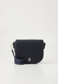 Borsa a tracolla in pelle blu navy con patta arrotondata, dettagli in metallo color oro e tracolla in tessuto con motivo logo ripetuto.