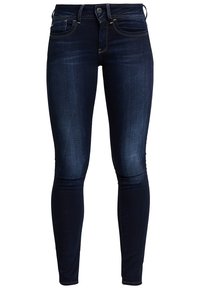 Jeans ajustados azul oscuro hechos de denim, con un diseño clásico de cinco bolsillos, ligero desvanecimiento y un sutil detalle de costura a lo largo de las costuras.