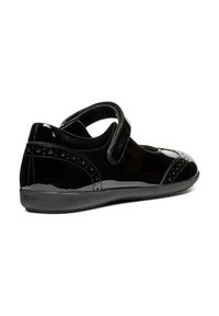 Black patent leather shoe with Velcro strap, rounded toe, decorative perforated detailing on the side, and a cushioned sole. Geox branding visible.