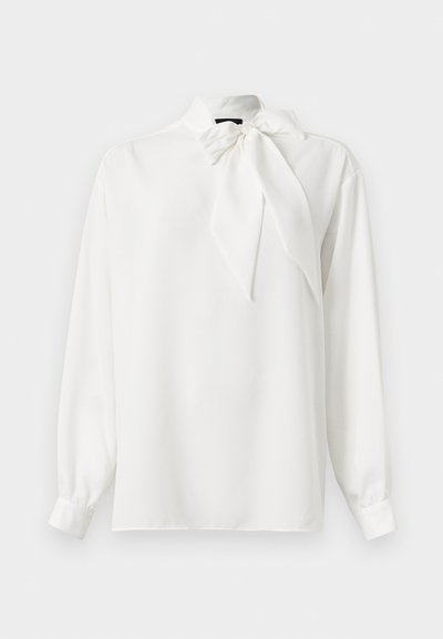 White long-sleeve blouse with a high collar and a large bow tied at the neck. Smooth texture, classic cut, and subtle sheen.