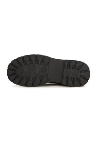Suela de zapato de goma negra con patrones de surcos, seis empuñaduras en forma de flor y una superficie texturizada para mayor tracción.