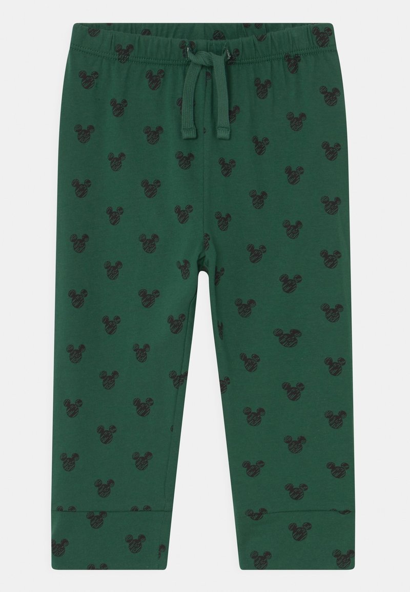 Pantalon pour enfant vert foncé avec des têtes de Mickey Mouse noires imprimées, taille élastique et cordon à l'avant.