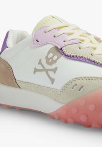 White sneakers with beige, pink, and purple accents. Features a skull graphic, suede and leather materials, and a textured pink outsole.