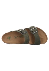 Green Birkenstock sandals with two adjustable leather straps and metallic buckles, featuring a contoured cork footbed and textured surface.