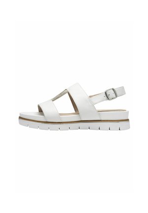 White sandal with cross straps and a buckle. Features a cushioned sole and textured accents. Overall design is lightweight and streamlined.