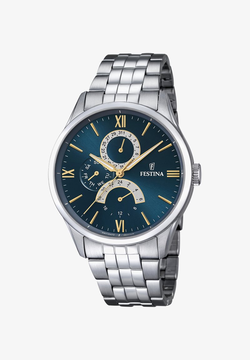 Sudraba nerūsējošā tērauda pulkstenis ar zilu ciparnīcu, zelta stundu atzīmēm, diviem subciparnīcām dienai/un datumam un strukturētu metāla lentu.