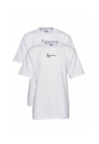 Two white cotton t-shirts with short sleeves, featuring a black cursive print logo on the chest. Simple design and classic shape.