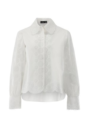 Weiße Bluse mit geschwungenem Saum, Knopfleiste und aufwändiger floraler Stickerei an Ärmeln und Körper. Lange Ärmel mit geknöpften Manschetten.