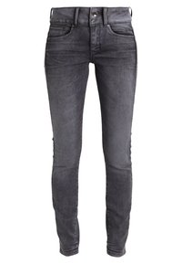 Jeans ajustados en denim gris oscuro. Diseño de cinco bolsillos con una textura suave, cierre de botón y un ligero desgaste en las piernas.