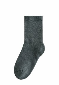 Calzini grigi a coste con rinforzo sul tallone e sulla punta. Texture morbida, lunghezza media fino al polpaccio e finitura liscia. Materiale in maglia leggero.