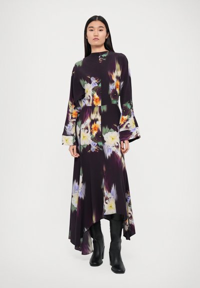 Long, floral-print dress in dark purple with bell sleeves and a high-low hem. Made of lightweight fabric featuring green, yellow, and blue accents.