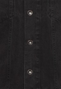 Black denim jacket featuring silver snap buttons down the front, with visible stitching and a classic collar design.