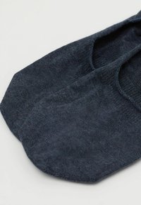 Svart bomullssocka med mjuk textur, med rund tå och låg klippdesign, lämplig för att bäras med olika skotyp.