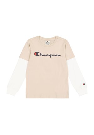 Beżowa koszulka z długim rękawem z białymi rękawami, z dużym granatowym logo 'Champion' na przodzie oraz małym logo na rękawie.