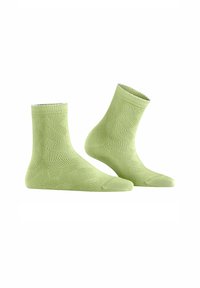 Grüne, gemusterte Knöchelsocken mit einem strukturierten Design und einem gewellten oberen Rand. Aus dehnbarem Material für Komfort und passgenauen Sitz.
