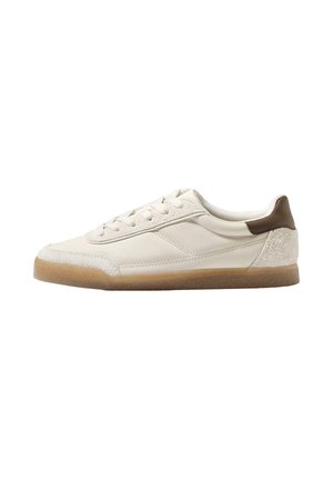 Sneaker bianca in pelle con tallone in suede tan testurizzato, suola in gomma color camel e lacci piatti. Caratterizzata da un design minimalista e dettagli cuciti.