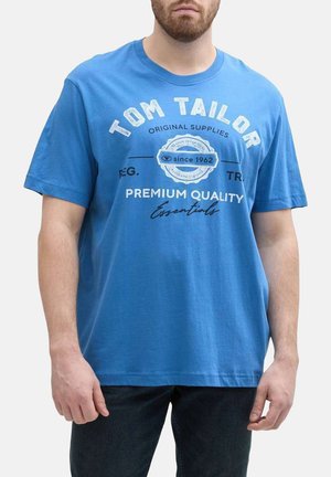 T-shirt en coton bleu avec col rond, manches courtes et logo imprimé sur la poitrine en blanc et noir.