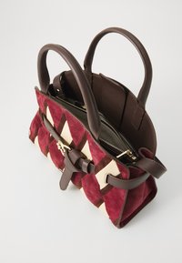 Red and beige handbag with a diamond pattern. Made of suede with brown leather accents and handles. Interior features a zippered compartment.