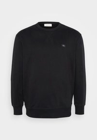 Svart sweatshirt med rund halsringning, långa ärmar, ribbade manschetter och nederkant samt en liten logotyp i tyg på bröstet. Mjuk textur.