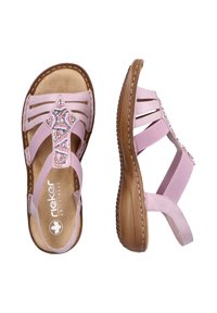 Sandales roses avec un design perlé, comportant plusieurs brides et une semelle rembourrée. Le matériau semble doux, avec une texture lisse.