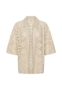 Cardigan crochet à devant ouvert de couleur crème avec des motifs floraux et géométriques, manches courtes et col pointu.