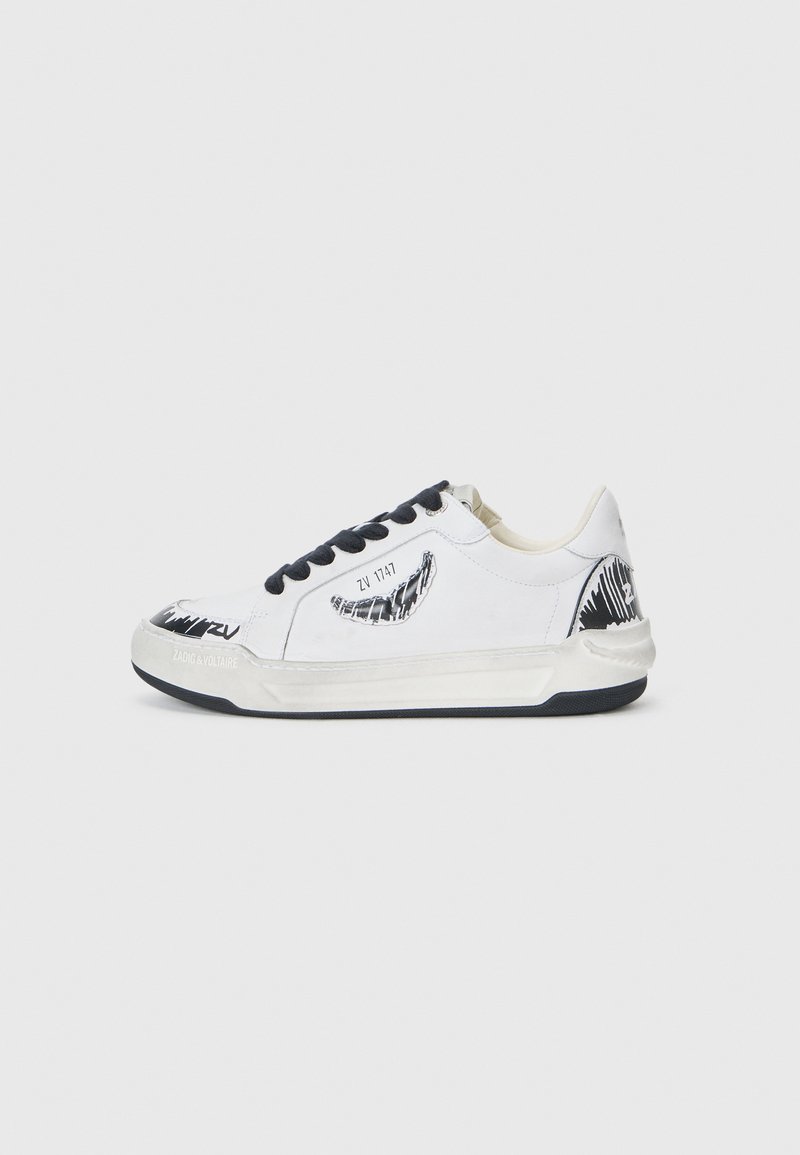 White sneaker with black accents, featuring a textured design on the side, black laces, and a rubber sole. Logo and artwork on the upper.