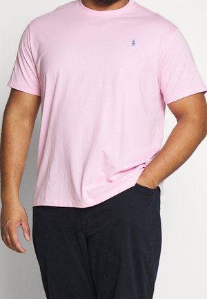 Maglietta rosa a maniche corte in cotone, con scollo rotondo e un piccolo logo blu ricamato sul petto a sinistra.