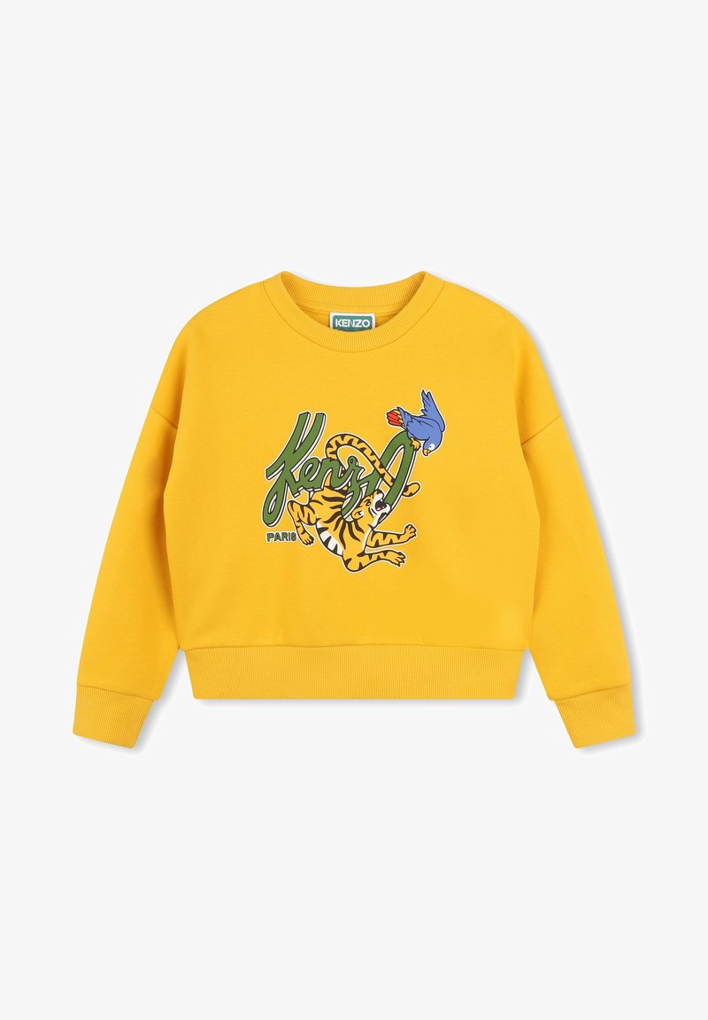 Sweat-shirt jaune court en tissu doux, comportant un imprimé graphique d'un tigre et d'un oiseau avec le texte "KENZO" en vert. Poignets et ourlet côtelés.