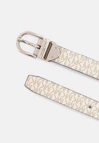 Beige fabric belt featuring a repeating logo pattern, with a silver metal buckle and trim. The strap includes holes for size adjustment.