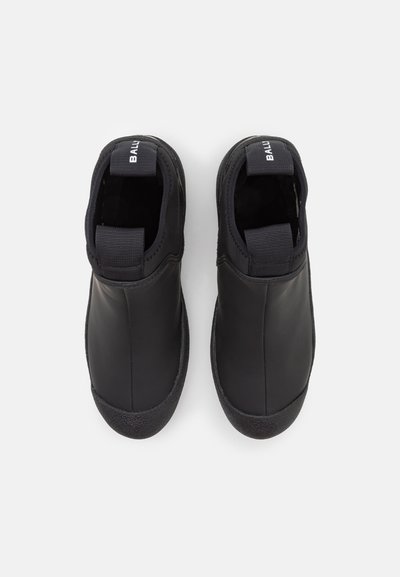 Pantofi slip-on negri din piele netedă, cu panouri elastice pe laterale, tălpi din cauciuc texturat și branding subtil pe toc.